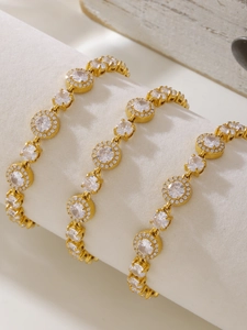 Close-up of three gold-plated tennis bracelets with 5A cubic zirconia on a jewelry display