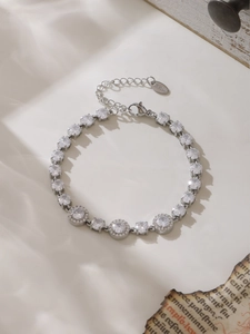 Detailed close-up of a silver stainless steel zirconia bracelet with lobster clasp