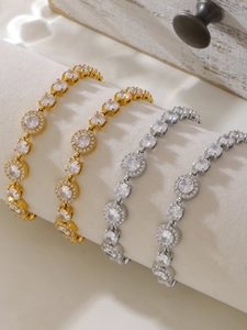 Detail of gold and silver halo tennis bracelets with 5A zircons on a jewelry roll