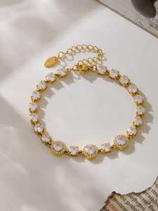 Macro shot of gold plated stainless steel bracelet with shimmering white zircon stones