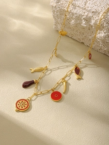Detail view of gold-plated paperclip chain necklace with bohemian multi-pendant charms