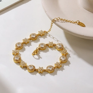 Detailed shot of gold plated stainless steel bracelet with sparkling zircon flowers