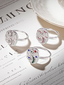 Detailed view of silver rings featuring celestial moon, star, and evil eye motifs with zircons