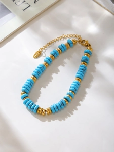 Detail of turquoise beads with gold spacers and S.Steel tag on a minimalist bracelet