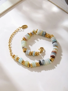 Detail of colorful natural stone beaded bracelet with gold stainless steel clasp