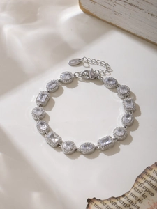 Dettaglio del bracciale scintillante in zircone geometrico con ciondolo logo S.steel