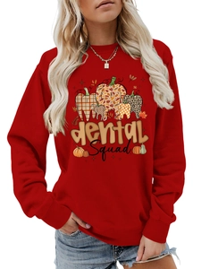 Detail of Dental Squad graphic on red long-sleeve sweatshirt with autumn pumpkin motifs