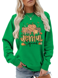Detail of Dental Squad printed sweatshirt with autumn pumpkin tooth graphics in green