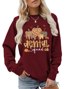 Detail of dental squad print on a soft maroon long sleeve crewneck sweatshirt
