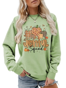 Detail of Dental Squad sage green sweatshirt with pumpkin teeth graphics and soft texture