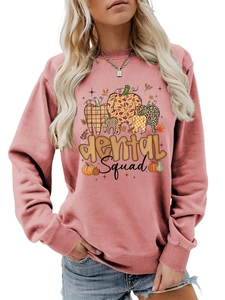 Pink crewneck sweatshirt detail featuring dental squad pumpkin design with leopard pattern