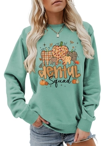 Close-up of Dental Squad pumpkin graphic on mint green long sleeve sweatshirt