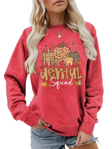 Detail of red crewneck sweatshirt with dental squad pumpkin graphics and ribbed cuffs