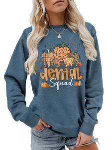 Close-up of blue dental squad sweatshirt with pumpkin teeth print for dentist women