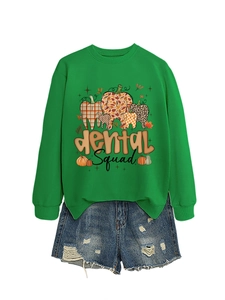 Detail of green Dental Squad sweatshirt paired with distressed blue denim shorts