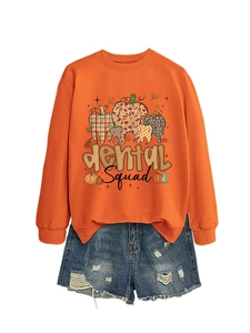 Detail of Dental Squad graphic sweatshirt with pumpkin texture print and denim shorts