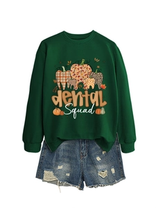 Detail of dark green Dental Squad sweatshirt with autumn pumpkin tooth graphics