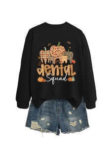 Detail of Dental Squad sweatshirt with tooth pumpkin graphic and ripped denim shorts