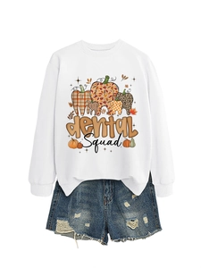 Detail of Dental Squad graphic sweatshirt paired with distressed denim shorts on white background