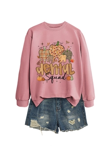 Detailed close-up of pink long sleeve sweatshirt with dental squad pumpkin print