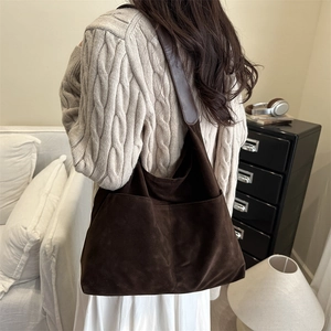 Retro dark brown frosted leather hobo bag with large capacity in a minimalist indoor setting