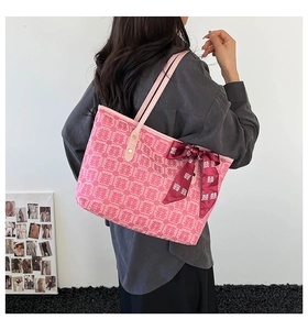Detailed pink jacquard tote bag with traditional pattern and decorative silk scarf