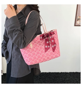 Detailed view of pink jacquard tote bag with traditional Xi character and silk scarf detail