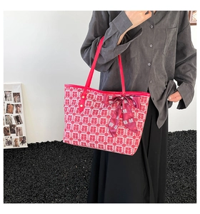 Detail of red and white Double Happiness jacquard tote bag with satin bow ribbon handle