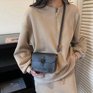 Classic black oil wax leather tote bag with white contrast stitching and buckle detail