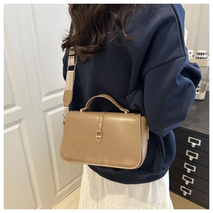 Detail of crossbody bag with wide strap shown on model for size and styling guide