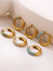 Detailed macro view of 18K gold-plated hoops with multicolored zircon and turquoise beads