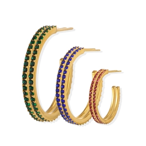 Three sizes of gold hoop earrings with green, blue, and purple cubic zirconia stones