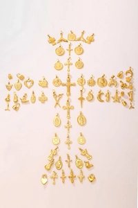 Collection of 18K gold plated charms and religious pendants arranged in a cross shape
