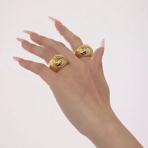Polished gold stainless steel rings featuring continuous embossed heart pattern design