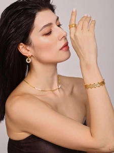 Elegant gold vintage jewelry set with pearls on model, featuring textured rings and necklace