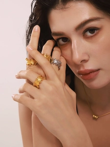 Irregular textured gold and silver rings with lava pattern and beaded edge detail