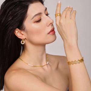 Polished 18K gold plated jewelry set with textured ring, open bangle, and pearl necklace