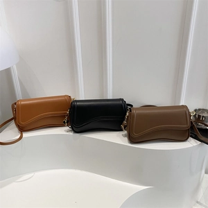 Minimalist leather crossbody bags in caramel, black, and dark brown with gold accents