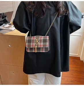 Classic red and black plaid crossbody bag with gold S-logo and fringe tassel detail