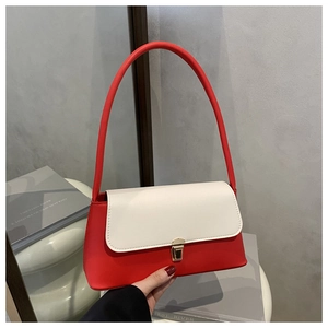 Close-up of red and white contrast baguette bag with gold square buckle and leather strap