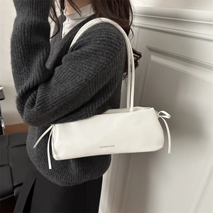White minimalist leather underarm bag with bow knots and Fashion & Bags text on bottom