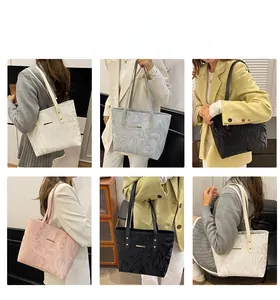 Detail of multi-color tote bags featuring fluid marble texture and gold metal accents