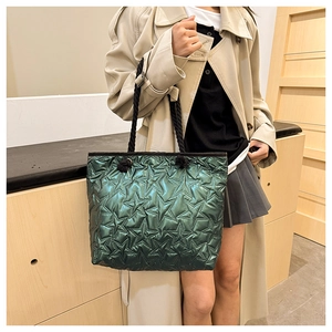 Detail of green glossy tote bag featuring star quilted pattern and rope handle straps