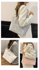 Detail of large tote bags with marble texture and elegant metal bar accents