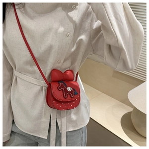 Close-up of a red mini crossbody bag with a bow and horse embroidery for girls