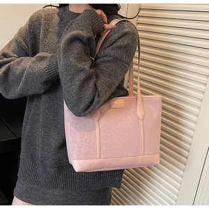 Detail of pink leopard embossed PU leather tote bag with gold metal fashion plaque