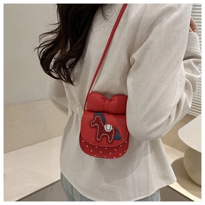 Detail of red quilted PU leather crossbody bag with bow and horse embroidery
