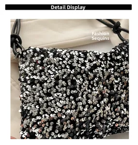 Macro shot of shimmering silver sequins and elegant black knotted leather handle details