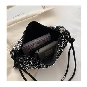 Interior view of black sequin shoulder bag showing storage capacity and inner lining
