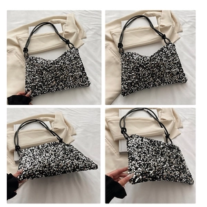 Macro detail of sparkly sequin shoulder bag with stylish black knotted strap design